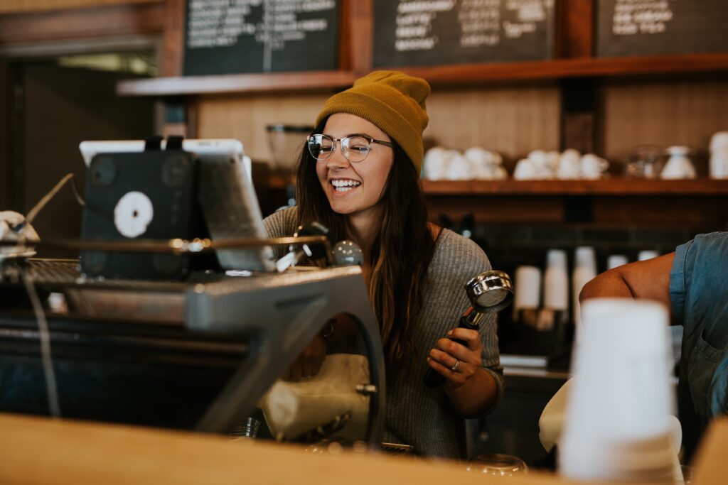 student barista making coffee